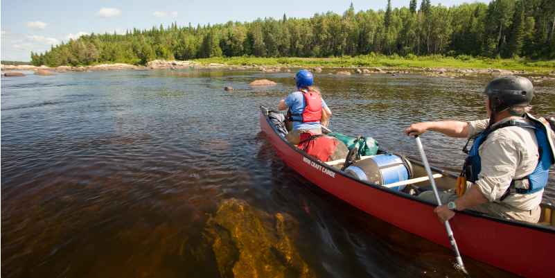 two people from MHO Adventures paddling down the missinaibi river